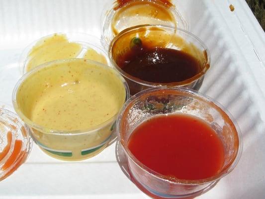 3 sauces: Texas style sweet and tangy, hot mustard sauce, and Carolina style vinegar sauce.