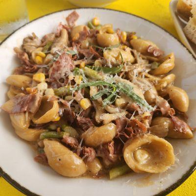 Orechiette pasta with prosciutto, corn, asparagus, maitake mushrooms, and a lobster tarragon cream sauce.