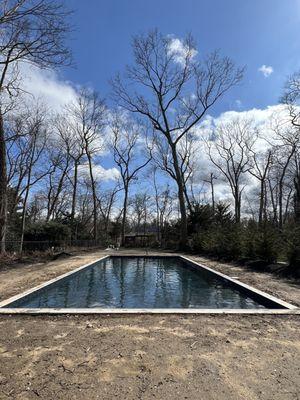 49'x20' salt water pool with 8'x20' sundeck. Stadium walk in steps after sundeck 20' wide. Excited for the pavers to go in!