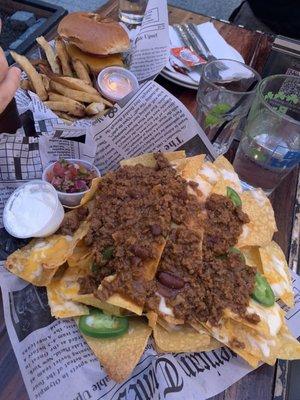 Nachos with chilli and hamburger