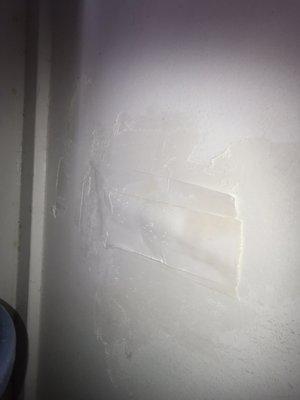 This is the patch after the hole was drilled for foam in the garage wall that's connecting inside the home