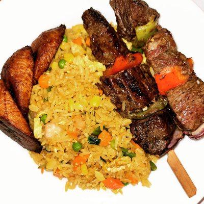 Fried rice served with Beef Kabobs and Plantains