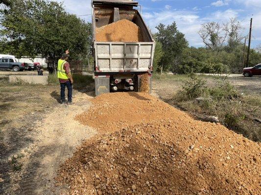 Gravel being delivered to road construction site