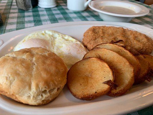 Chicken fried steak, home fries, eggs and light fluffy biscuit