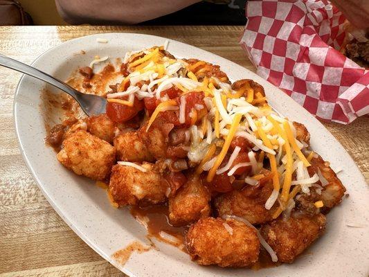 Chili cheese tater tots with onions, jalapeños and ranch dressing