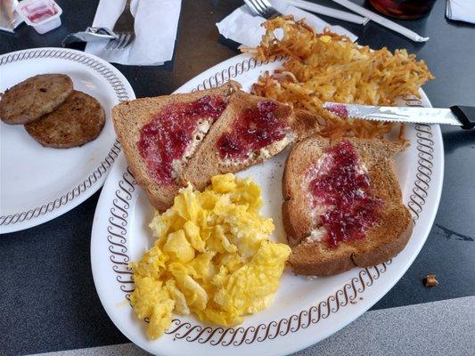 2 eggs scrambled, wheat toast with jelly, and hash browns and sausage patties.