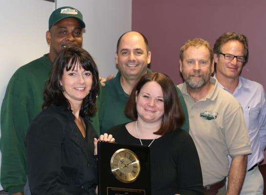 Bill Roy Operations Team accepting the Service Excellence Award from Melissa A. Gaither, Vendor Manager of Darling International