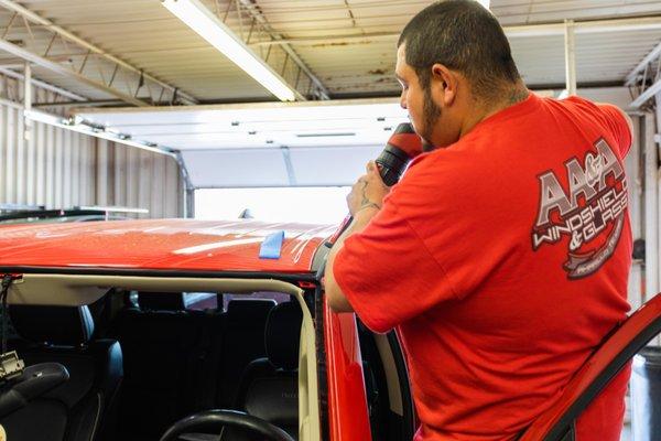 Adding new adhesive for a new windshield.