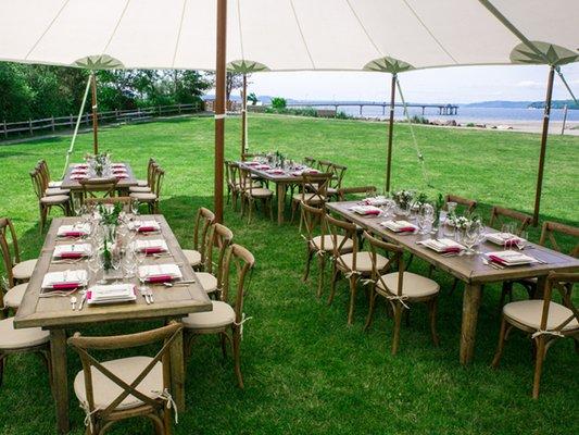 Tidewater canopy, vineyard tables, vineyard chairs and a minimalist square plate setting.