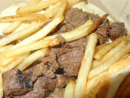 A close-up of one of my Steak + Eggs Tacos. ... The fries and steak look better than they were.