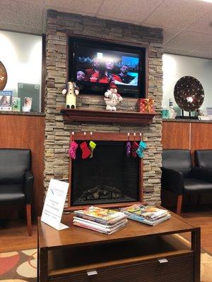 Patient waiting area with magazines, cozy seating and neutral decor