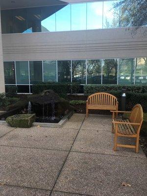 A nice quiet seating area with a water fountain and wooden park benches in case you bring friends or family.