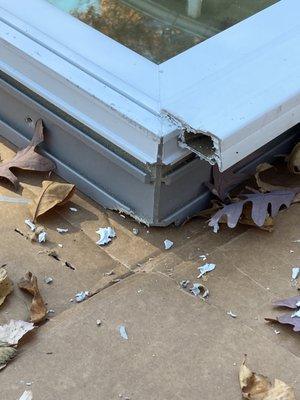 Broken window laying on the ground after the installers dropped it