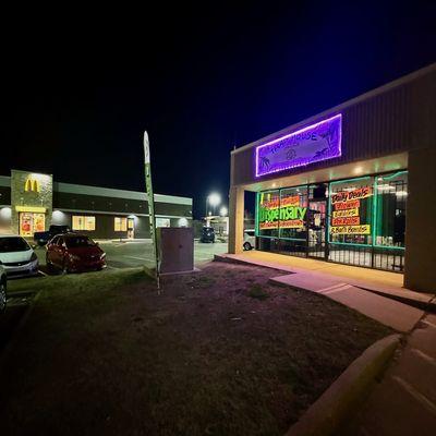 Night at Traphouse Dispensary, with McDonald's in view. A landmark for quality cannabis in Broken Arrow. #CannabisCulture #BrokenArrow