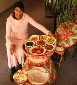 Owner Neghisti Ghebrehiwot by some of her exquisite dishes