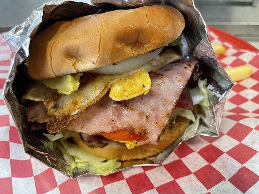 Try our Delicious Mexican Hamburger which includes ground beef, Avocado, egg, ham, bacon, cheese, mayo, mustard, lettuce, tomato, and onion!