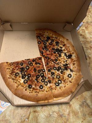 A very sad olive pizza that is lacking cheese