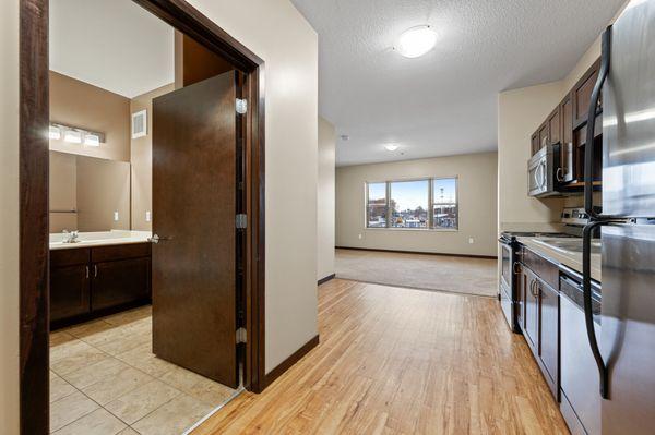 View of bathroom, living room, and kitchen.