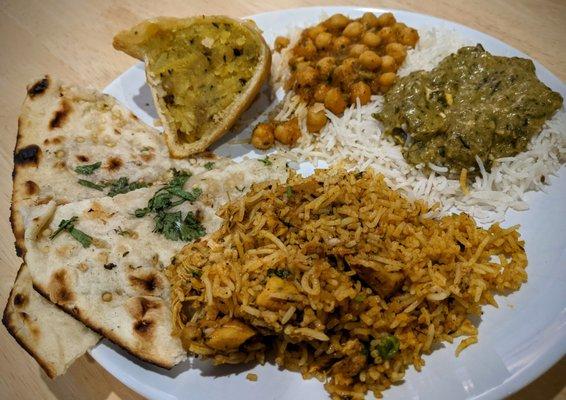 Garlic naan, half (!!) a samosa, channa masala, saag paneer, and chicken biriyani. Delish!