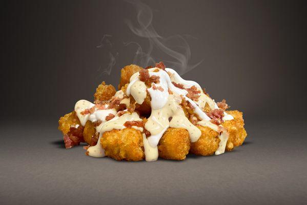 Cheesy bacon tots with sour cream.