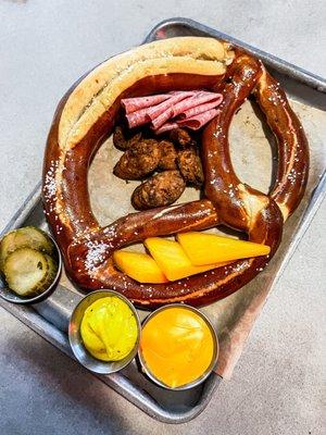 Pretzel with seasonal meats and cheese