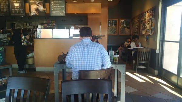 Guy sitting at handicapped table, but doesn't appear handicapped at all. BUT it gets worse. Starbucks interviewer there 4 40 min