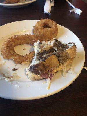 What's left of our Reuben and onion rings. Very good!