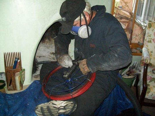 K.C. at work cleaning a kiva fireplace