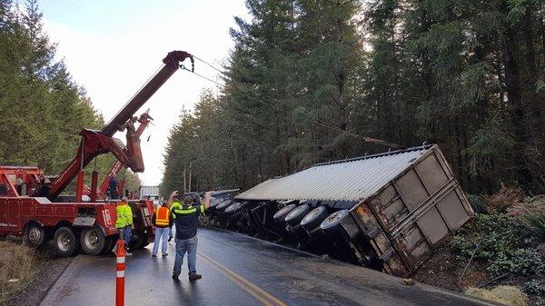 Carl's towing recovering a  big rig  that slid off the side of the road.