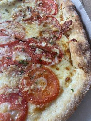 White pie with garlic, tomato, and mozzarella