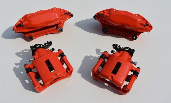 Custom painted brake calipers. These were media blasted in-house. Then properly etched to allow the paint to bite to the metal.