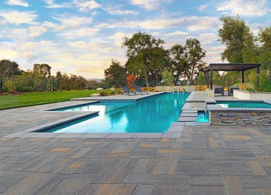 Modern paving stone pool deck and pool walkway