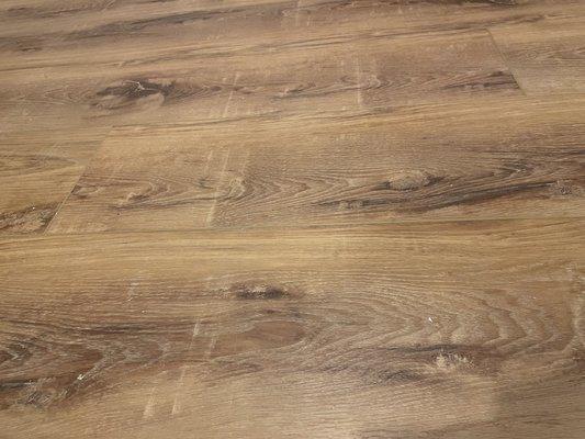 Horrible "distressing " on flooring that is not labeled as distressed.