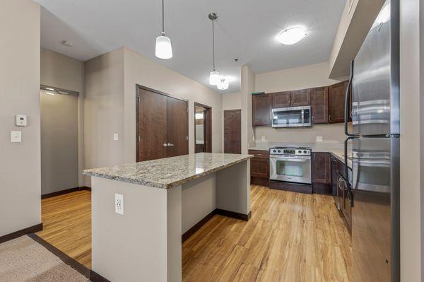 Kitchen island, stainless steel appliances, and granite counter tops.