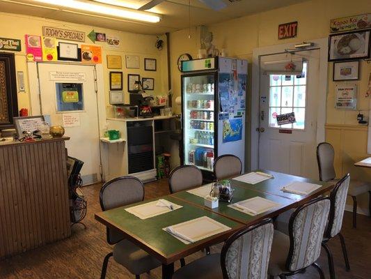 Small dining area with two 2-person tables and several other 4-toppers. No one at 5:15 on a Tuesday in summer but plenty of to-go customers.