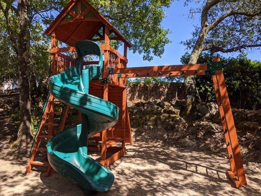 Backyard Adventures Olympian Treehouse Jumbo with open spiral slide and monkey bars