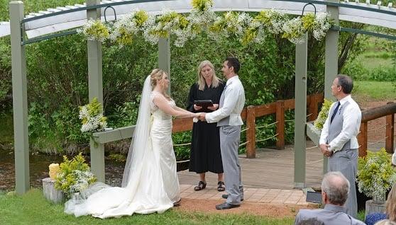 The beautiful ceremony space and the flowers decorating the arch. Photo by Custom Creations