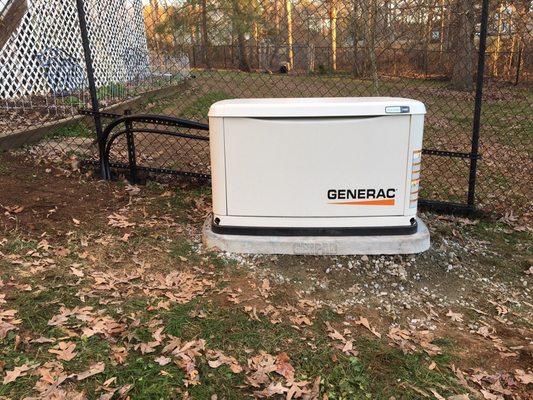 11kw standby Generac Generator with 100 amp 16 circuit automatic transfer switch installed on a 4" genpad