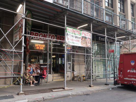 Storefront, with ubiquitous NYC scaffolding.