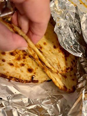 Naan, thin and chewy like the frozen kind.