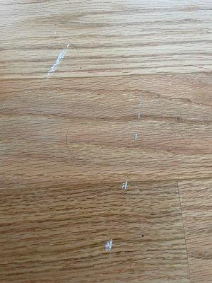 Scratches on our hardwood floor that we cannot get off and was not there before.