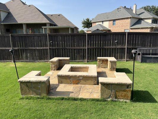 Backyard home improvement with flagstone masonry fire pit and paver capping