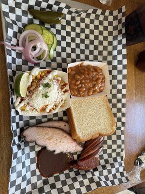 Two meat plate with turkey jalapeño sausage with Mexican corn, and baked beans.