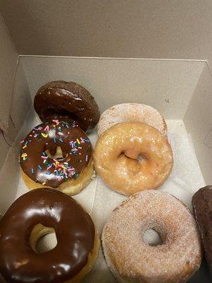 Chocolate donut, chocolate cake donut ,sugar donut and strawberry shortcake donut.