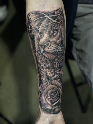 Black and grey lion and cub tattoo with clock rose