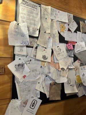 Community board full of cat drawings!