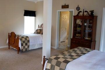 1st floor guest suite includes kitchen, queen and twin beds, full bath, and laundry area.