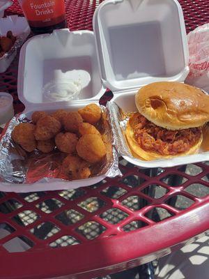 Perfectly smoked pulled pork sandwich.  Hot fresh breaded mushrooms