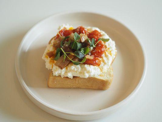 Our ricotta and tomato toast. Lots of house made ricotta, sautéed tomatoes, pancetta and microgreens.