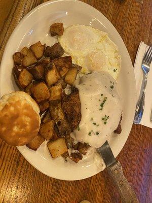 Chicken Fried Steak with over easy eggs home fries and a biscuit